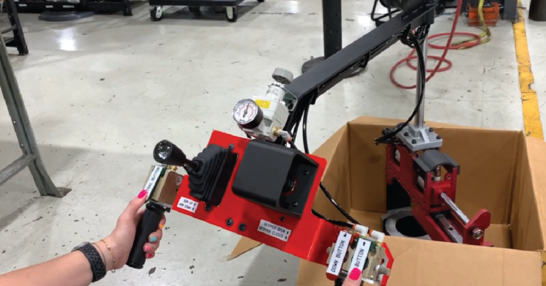 machine tending lift assist arm handling 50 pound part